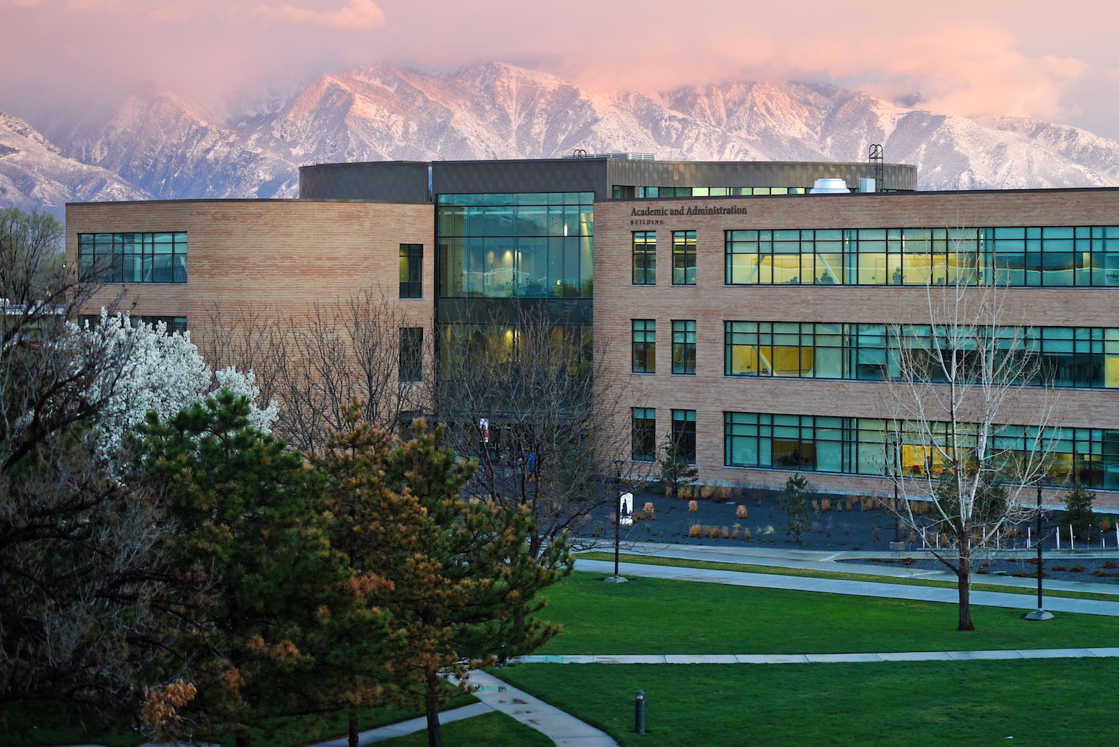 Man painting pottery in front of brick wall.