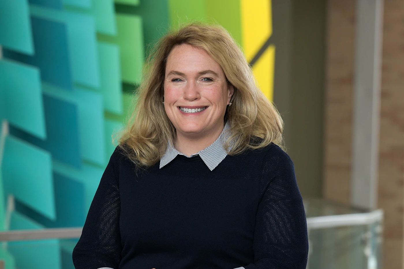 Photo of Dr. Brenda Madore smiling against a geometric background.