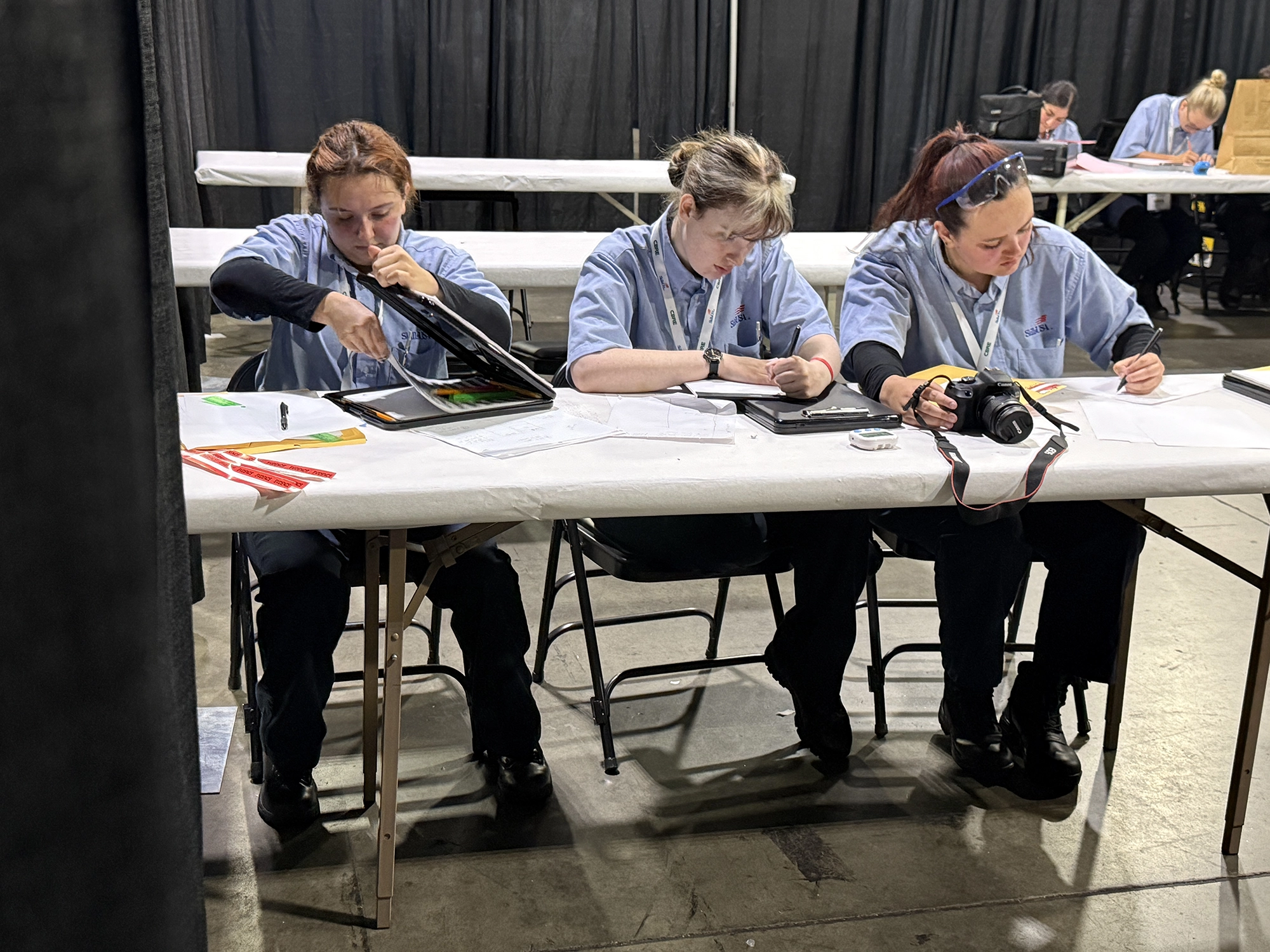 SLCC Forensic Science Students, left to right, Kennedi Leon, Kylee Hermeling and Haylee Ramirez and sit at a table and work out the answer to a question on paper, at the National Skills USA competition.