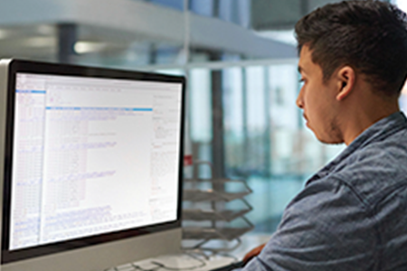 a man looking at code on his computer